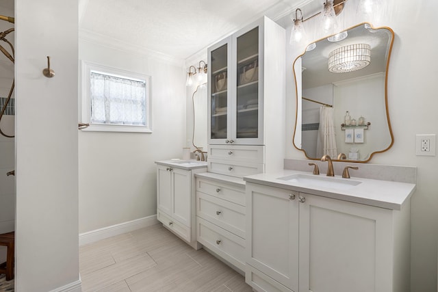 bathroom with vanity, crown molding, and curtained shower