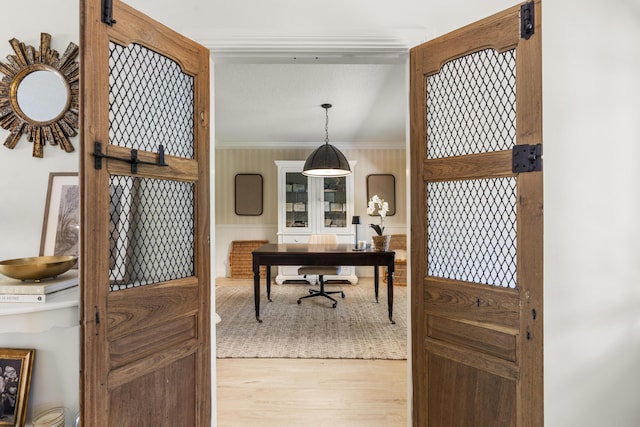 office space featuring ornamental molding and light hardwood / wood-style flooring