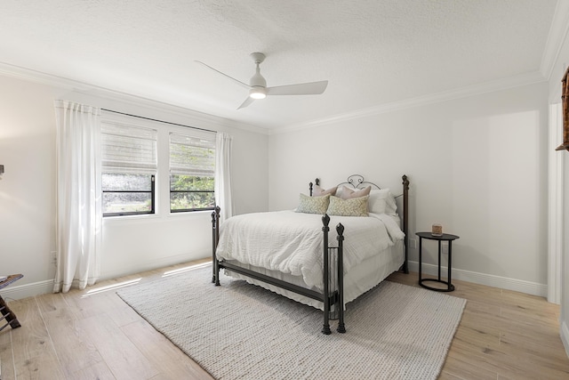 bedroom featuring ceiling fan, crown molding, and light hardwood / wood-style flooring