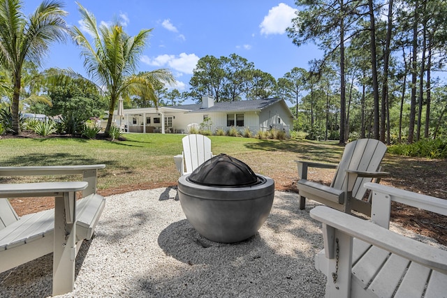 view of yard with an outdoor fire pit and a patio area