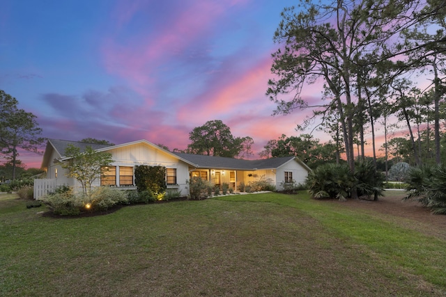 ranch-style house featuring a lawn