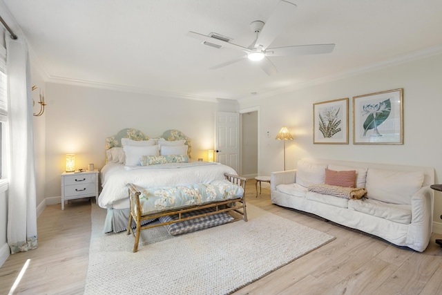 bedroom featuring ceiling fan, hardwood / wood-style flooring, and ornamental molding