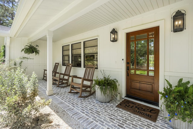 view of exterior entry with a porch