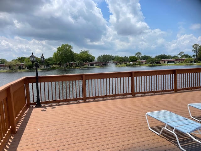 wooden terrace featuring a water view