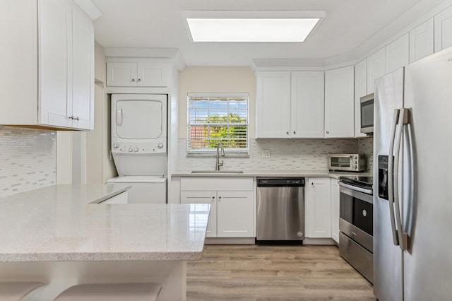 kitchen featuring light hardwood / wood-style floors, stainless steel appliances, white cabinetry, and sink