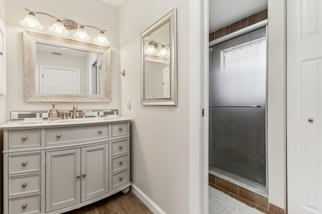 bathroom with hardwood / wood-style floors and large vanity