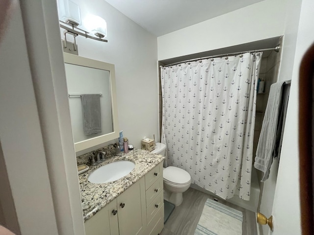 full bathroom with toilet, shower / tub combo with curtain, vanity, and wood-type flooring