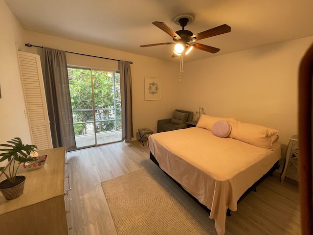 bedroom featuring light hardwood / wood-style floors, access to exterior, and ceiling fan