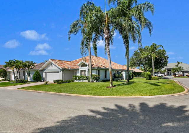 view of front of house with a front lawn and a garage