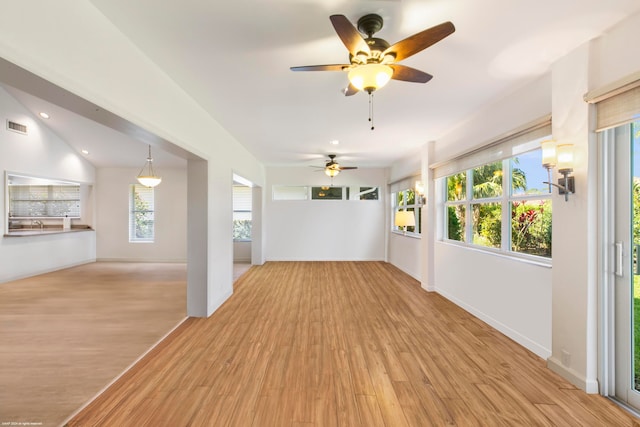 unfurnished room featuring plenty of natural light, light hardwood / wood-style flooring, and ceiling fan