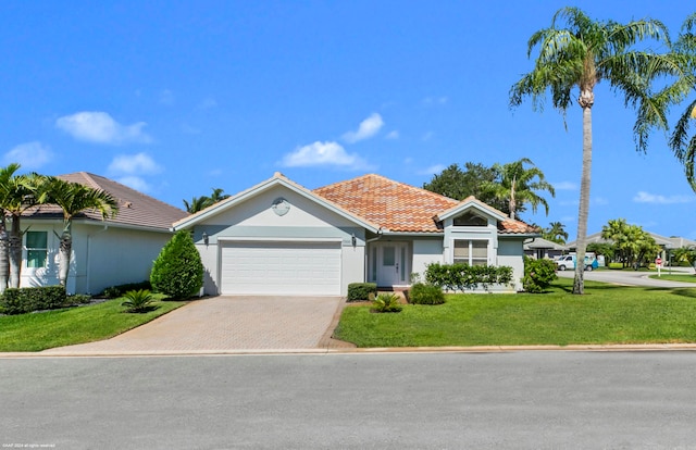 view of front of property featuring a garage and a front lawn