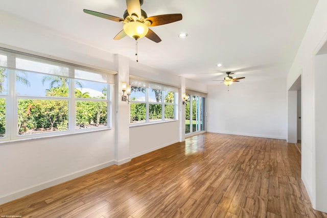 empty room with hardwood / wood-style flooring and ceiling fan