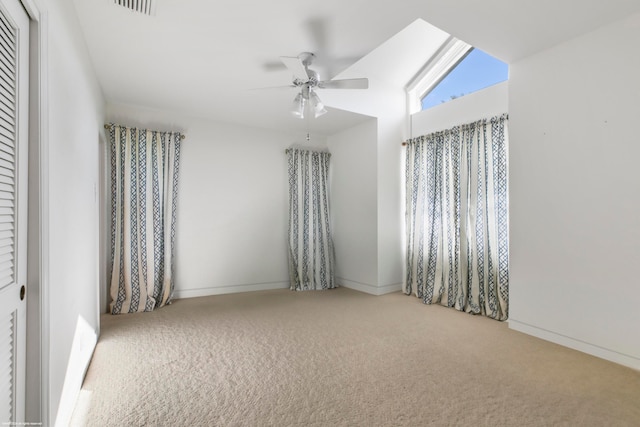 unfurnished room with ceiling fan, carpet floors, and lofted ceiling