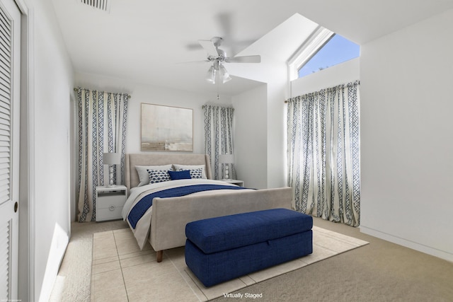 bedroom featuring a closet, ceiling fan, and light carpet