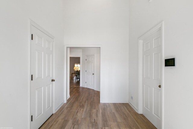 hallway with hardwood / wood-style floors