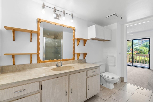 bathroom featuring toilet, tile floors, and vanity with extensive cabinet space