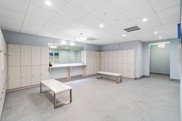 interior space with light tile flooring and a paneled ceiling