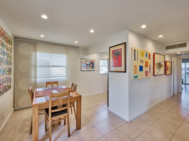 dining area featuring light tile floors