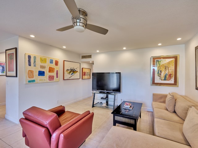 tiled living room with ceiling fan and a textured ceiling