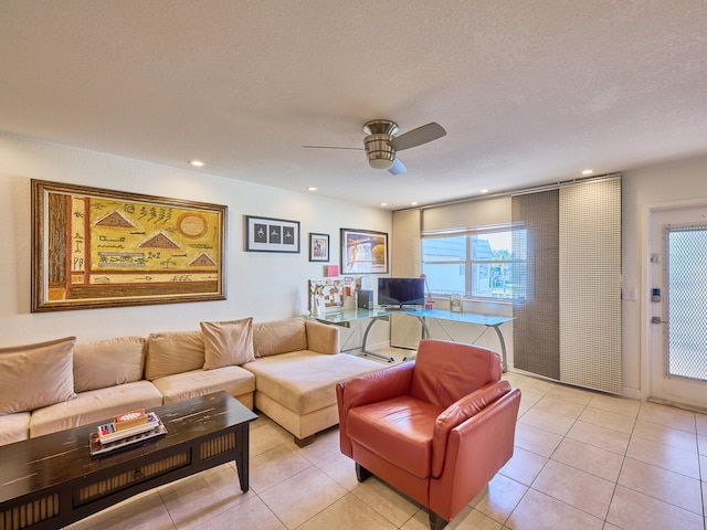 tiled living room with ceiling fan and a textured ceiling