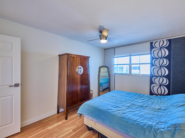 bedroom with light hardwood / wood-style flooring and ceiling fan