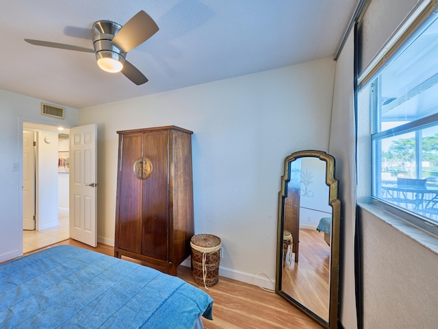 bedroom featuring ceiling fan and light tile floors