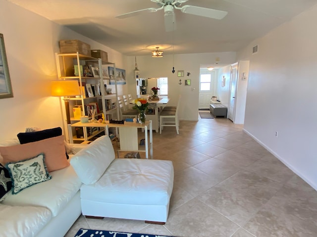 tiled living room featuring ceiling fan