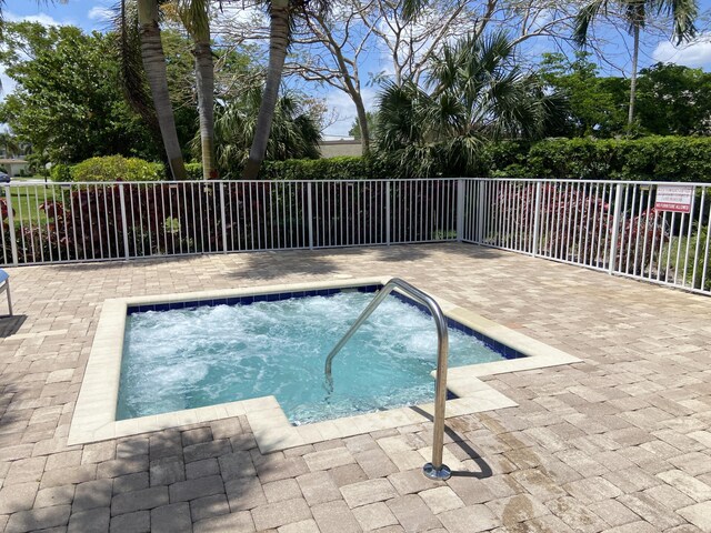 view of pool with a hot tub