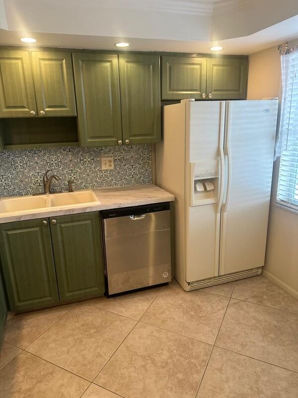 kitchen with dishwasher, white fridge with ice dispenser, sink, and light tile patterned floors