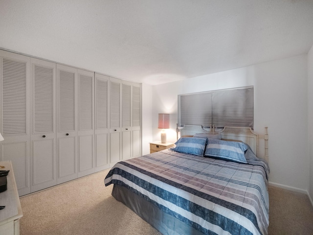 carpeted bedroom featuring a closet and a textured ceiling