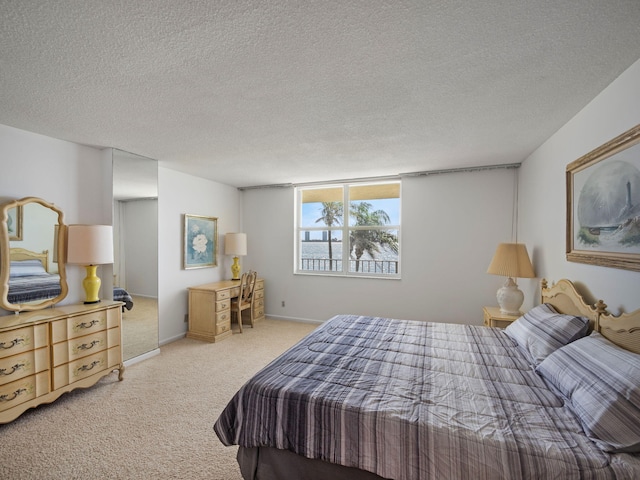 carpeted bedroom featuring a textured ceiling