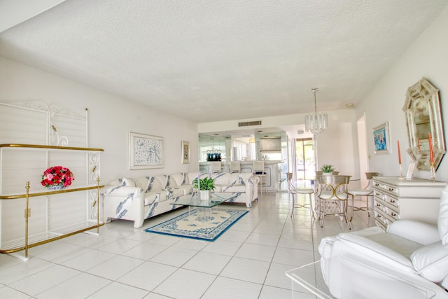 tiled living room with a textured ceiling and a notable chandelier