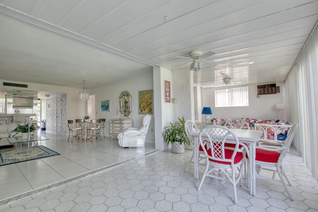 unfurnished dining area featuring a wealth of natural light, ceiling fan, and light tile flooring