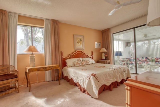 bedroom featuring ceiling fan, carpet, access to exterior, and a textured ceiling