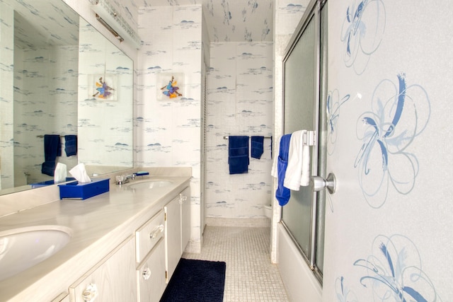 bathroom with tile floors, dual vanity, and enclosed tub / shower combo