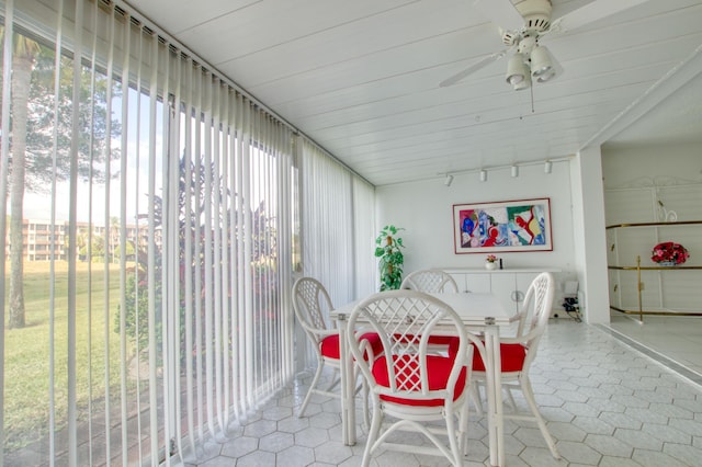 sunroom with ceiling fan and track lighting