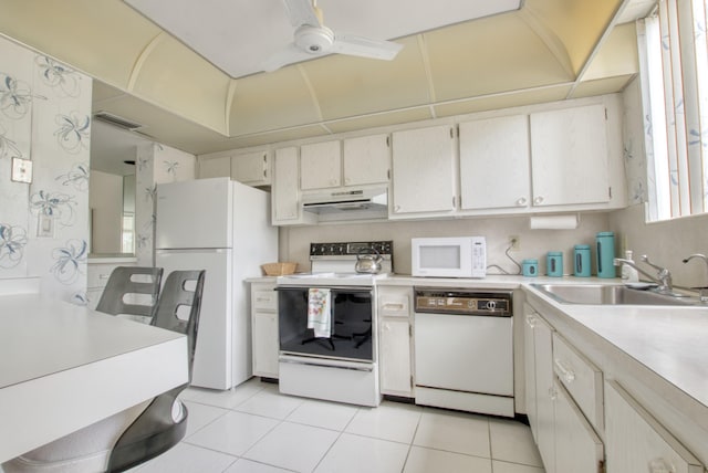 kitchen featuring white appliances, ceiling fan, white cabinets, sink, and light tile floors