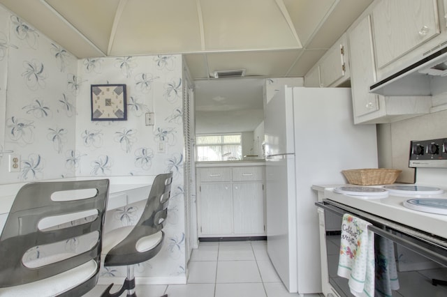 kitchen featuring white cabinets, white range with electric cooktop, light tile flooring, and custom range hood