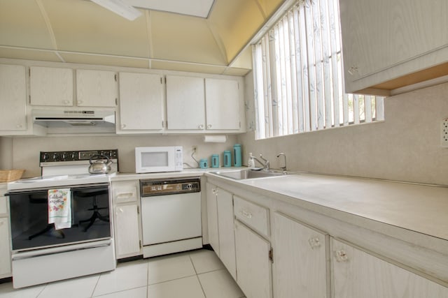 kitchen featuring light tile floors, range hood, white appliances, and sink