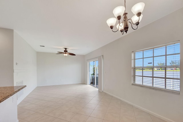 unfurnished room with light tile flooring and ceiling fan with notable chandelier