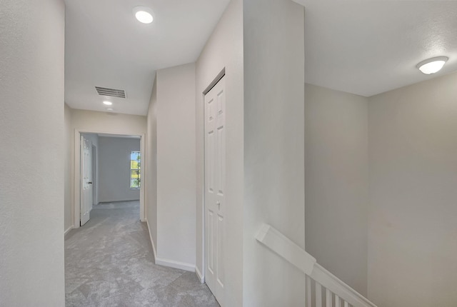 hallway featuring light carpet