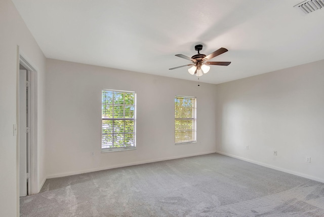 carpeted spare room featuring ceiling fan