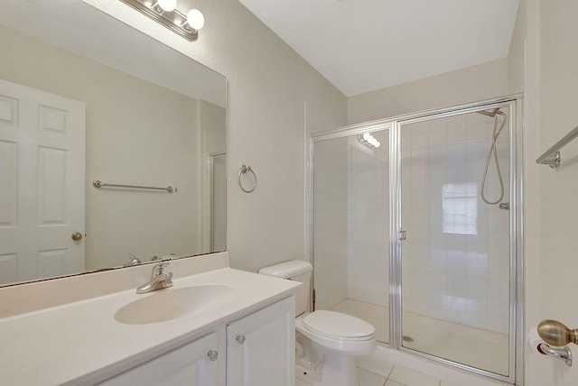 bathroom featuring a shower with door, vanity, toilet, and tile floors