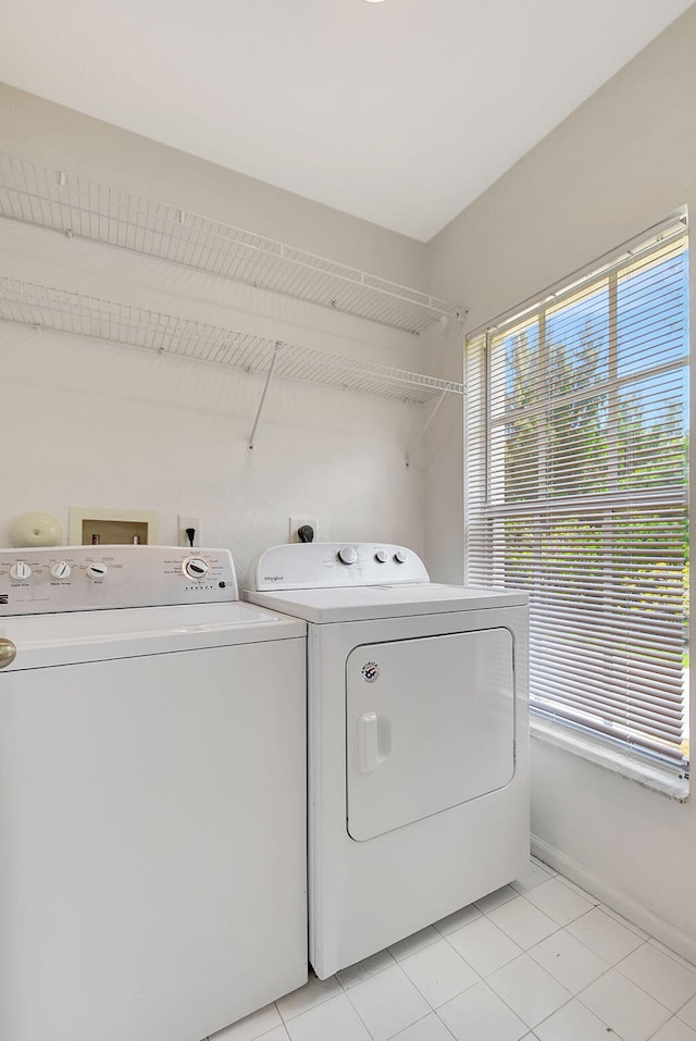 laundry room featuring independent washer and dryer, hookup for an electric dryer, and light tile flooring