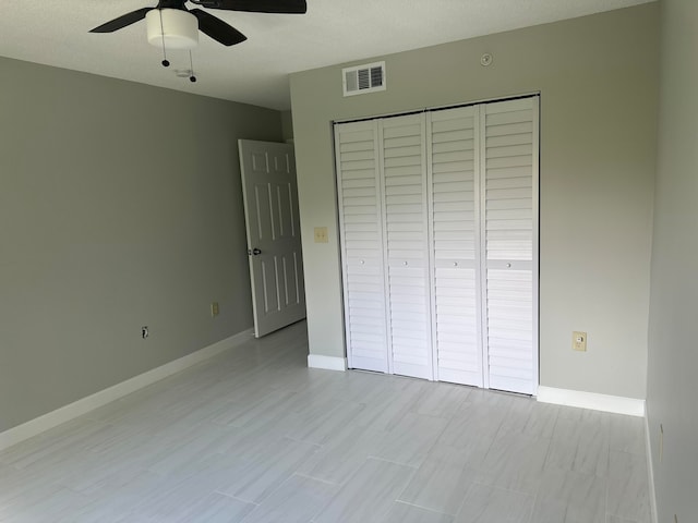 unfurnished bedroom featuring a closet, a textured ceiling, and ceiling fan