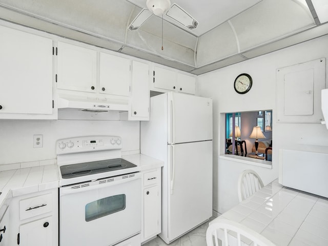 kitchen featuring white cabinets, tile countertops, white appliances, and light tile floors