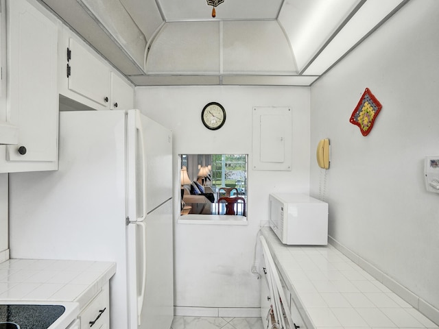 kitchen featuring tile countertops, white cabinetry, and light tile floors