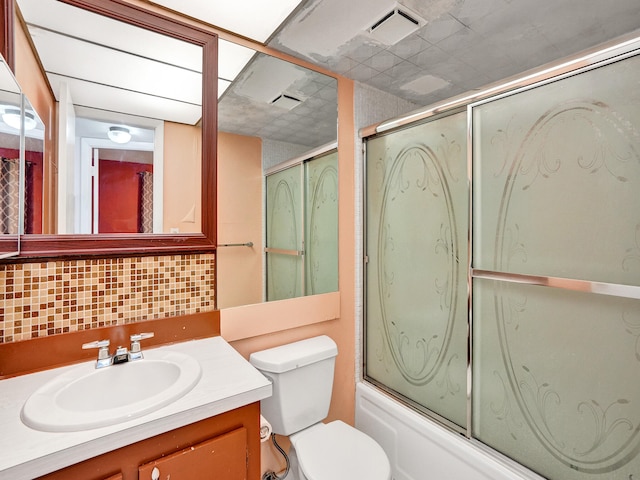 full bathroom featuring enclosed tub / shower combo, backsplash, vanity, and toilet