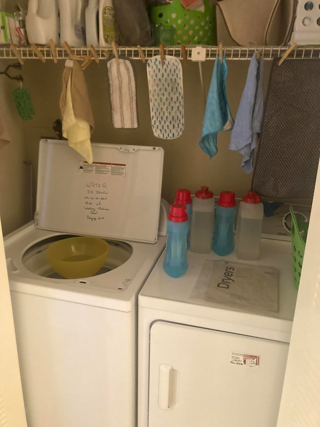 laundry room with washing machine and clothes dryer