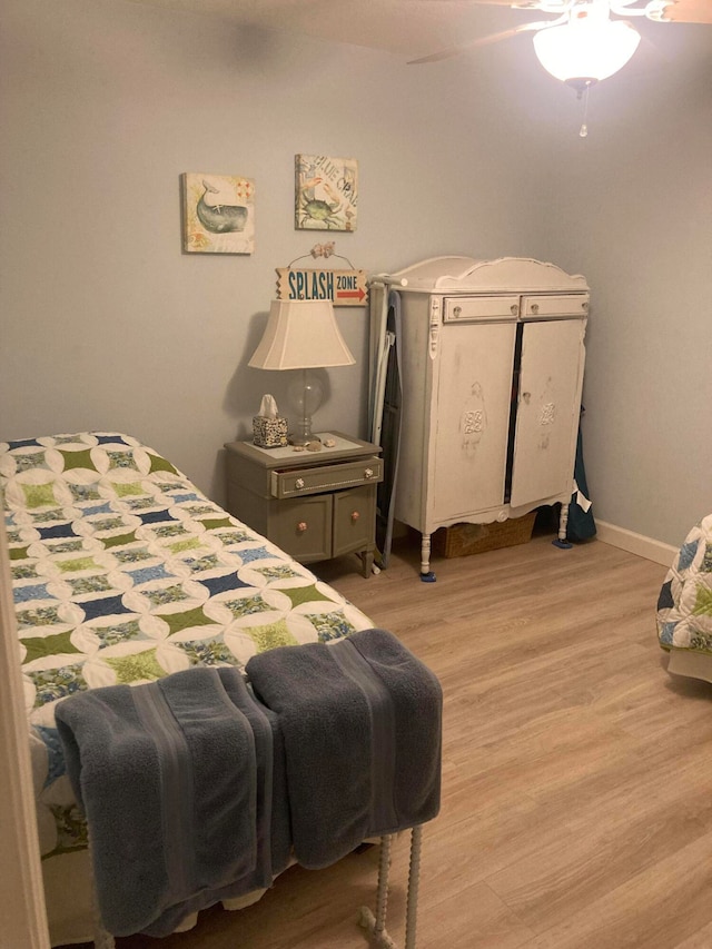 bedroom with light hardwood / wood-style floors and ceiling fan